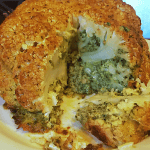 A plate of The Best Whole Roasted Cauliflower with Greens Butter Stuffing